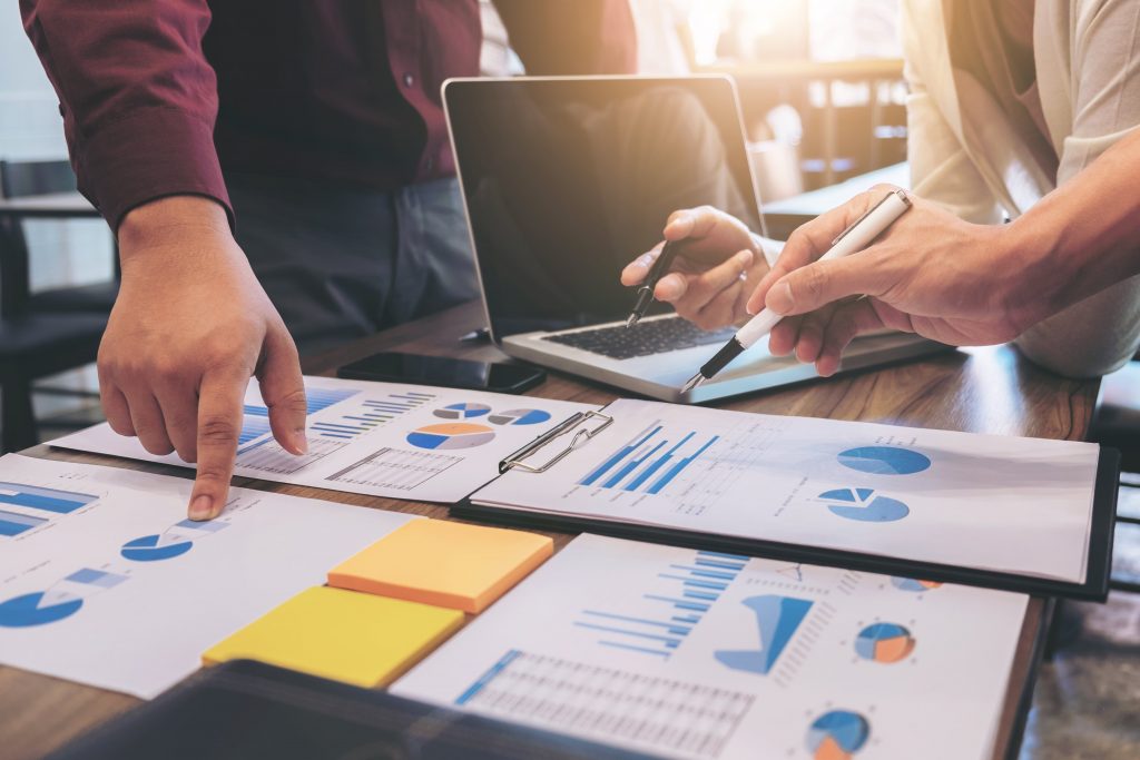 close-up-colleagues-working-desk-min